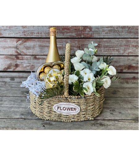 A box of flowers, chocolate and wine in a basket